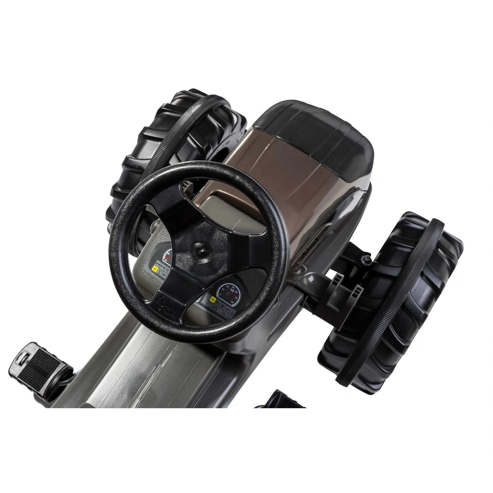 ROLLEY TOYS - rollyFarmtrac Premium II Valtra features a black steering wheel with a silver center and a glossy dashboard.