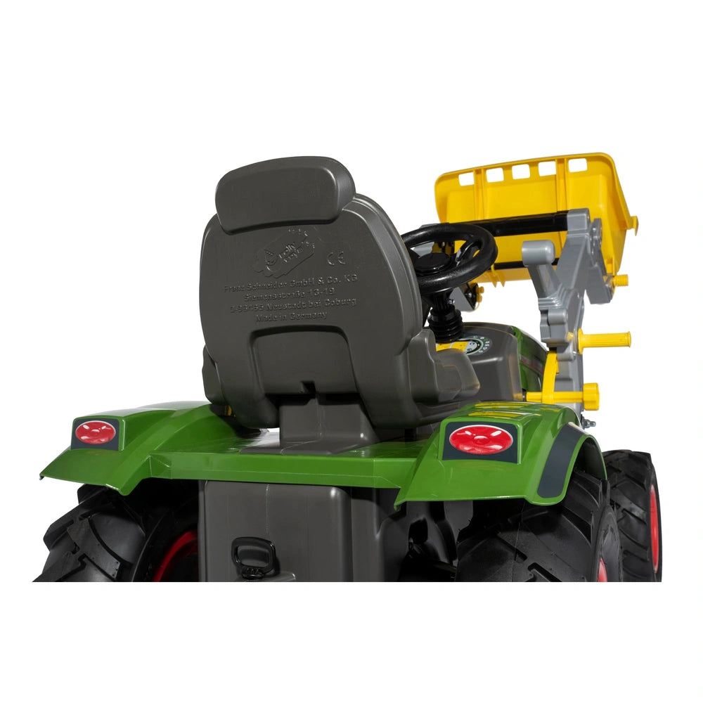 Rolly Farmtrac Fendt 211 Vario toy tractor in green with yellow attachment, black wheels, and red rims against a white backgr