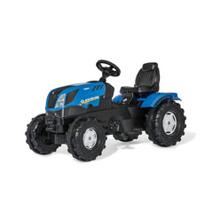 Rolly Toys New Holland T7 tractor riding toy in blue with black rubber wheels, upholstered seat, and glossy dashboard.