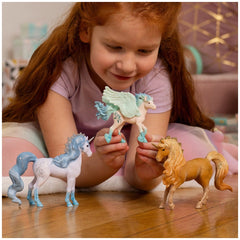 Flowy Unicorn Mare figurine is held by a smiling girl with red hair, sitting on a soft pastel surface, showcasing her joy.