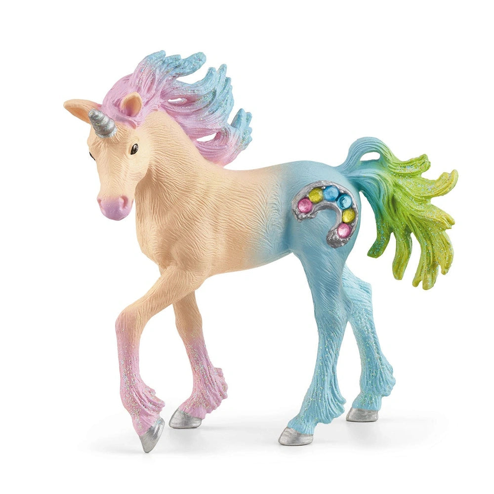 Marshmallow Unicorn Foal toy figure features a pink body, glittery mane and tail, and a metallic silver horn on a white surfa