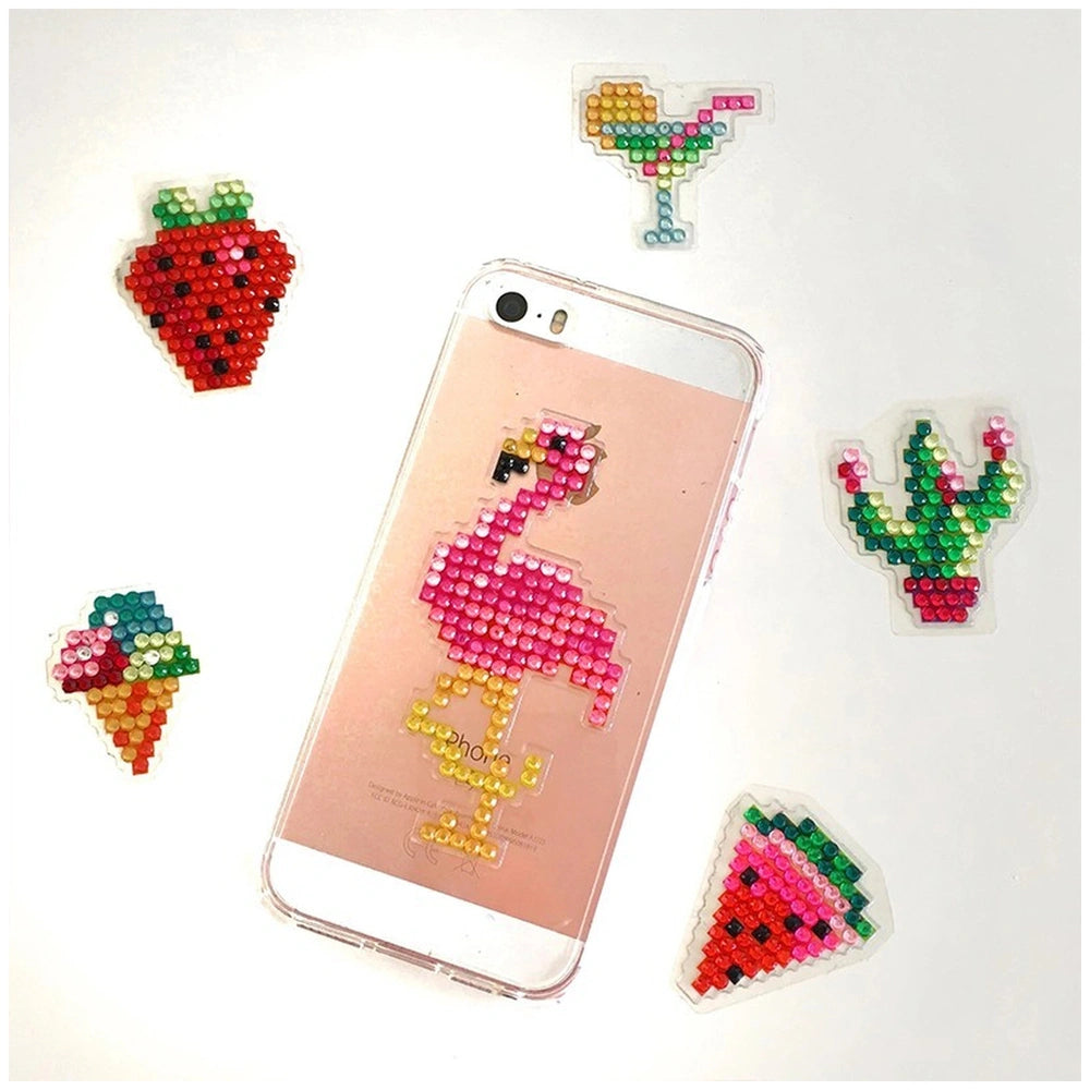 Diamond stickers in vibrant colors are scattered around a smartphone with a clear back cover on a white surface.