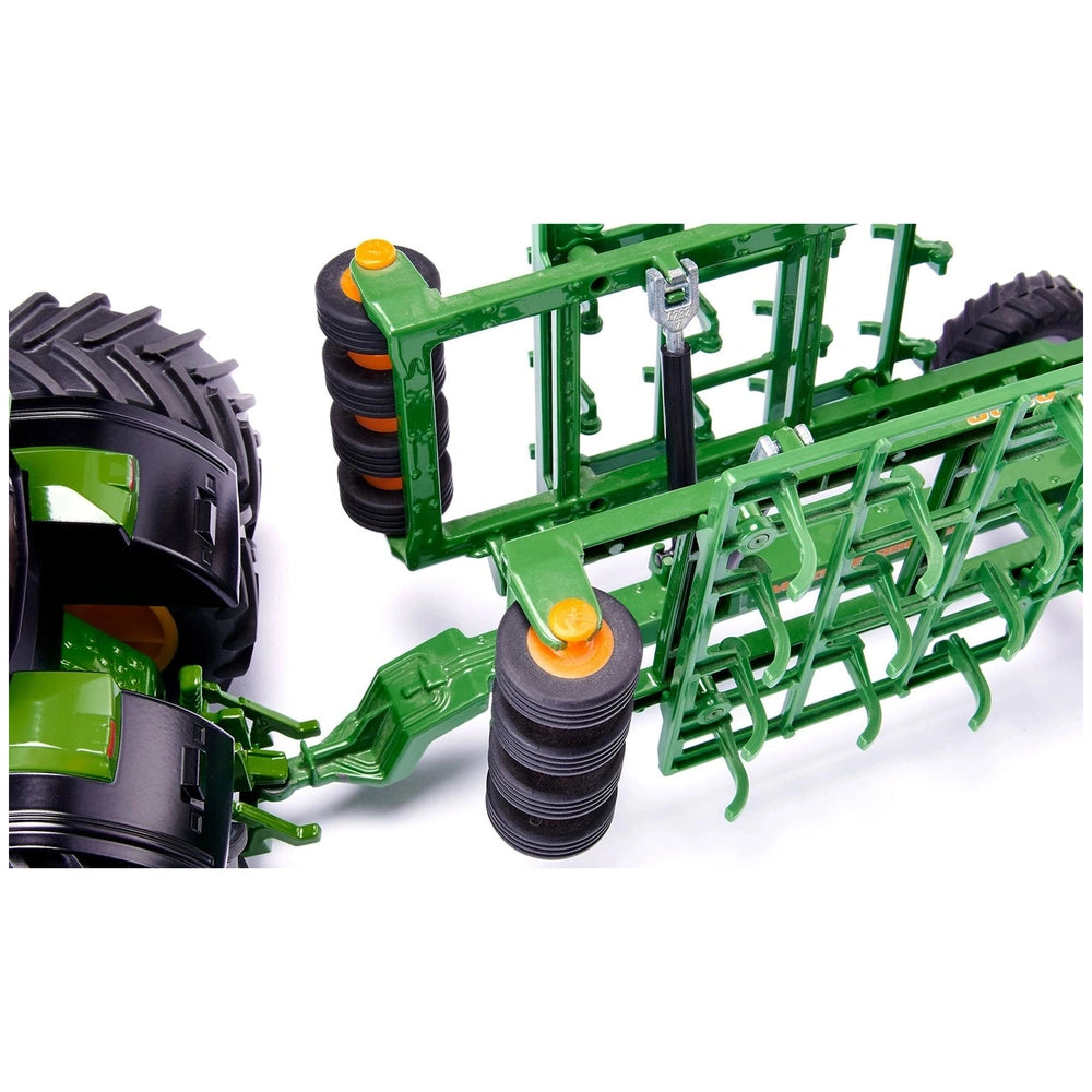 A green and black agricultural tractor attachment with blades for tilling soil, displayed against a white background.
