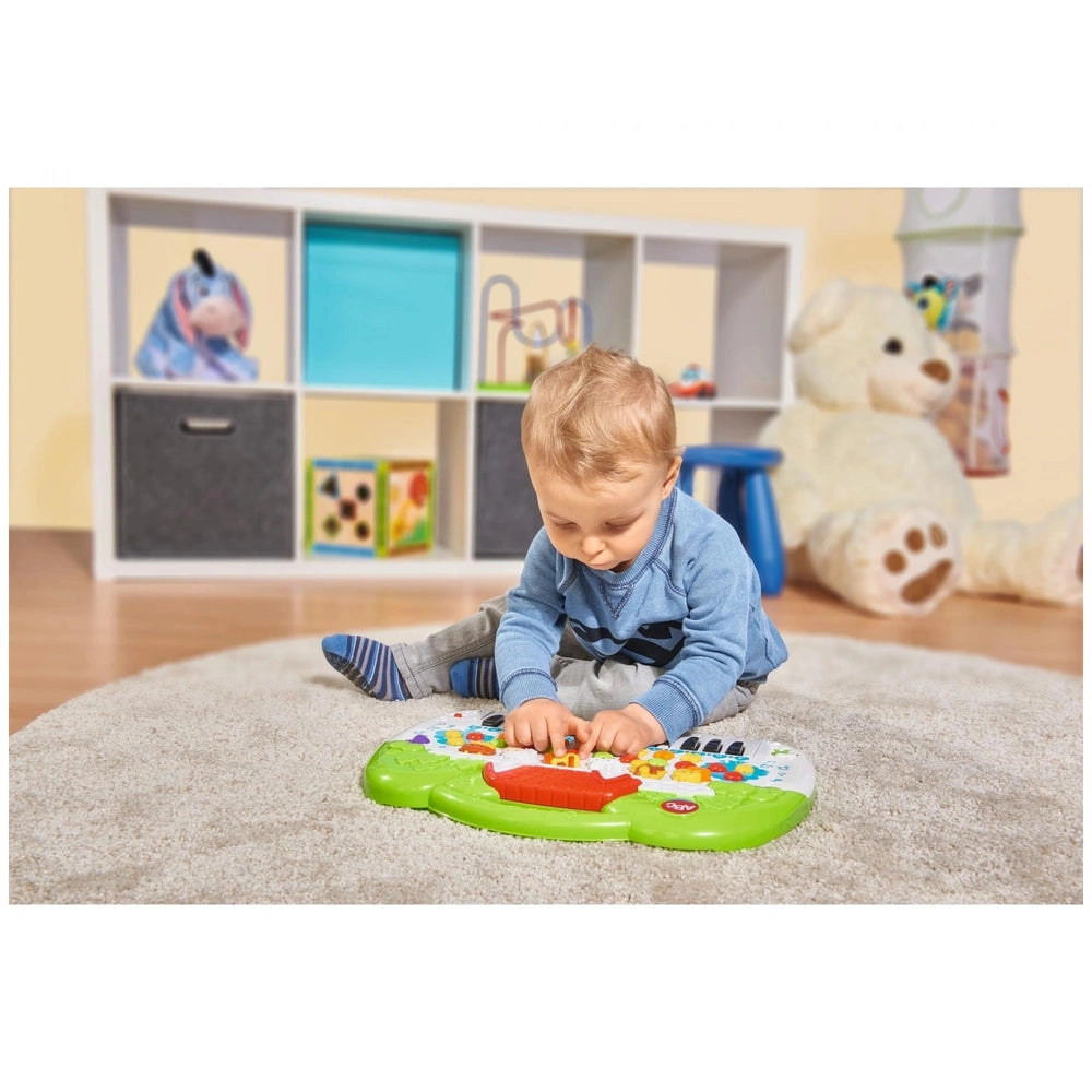 Simba ABC Animal Keyboard - Young child playing with a colorful toy keyboard on a beige carpet in a bright playroom.