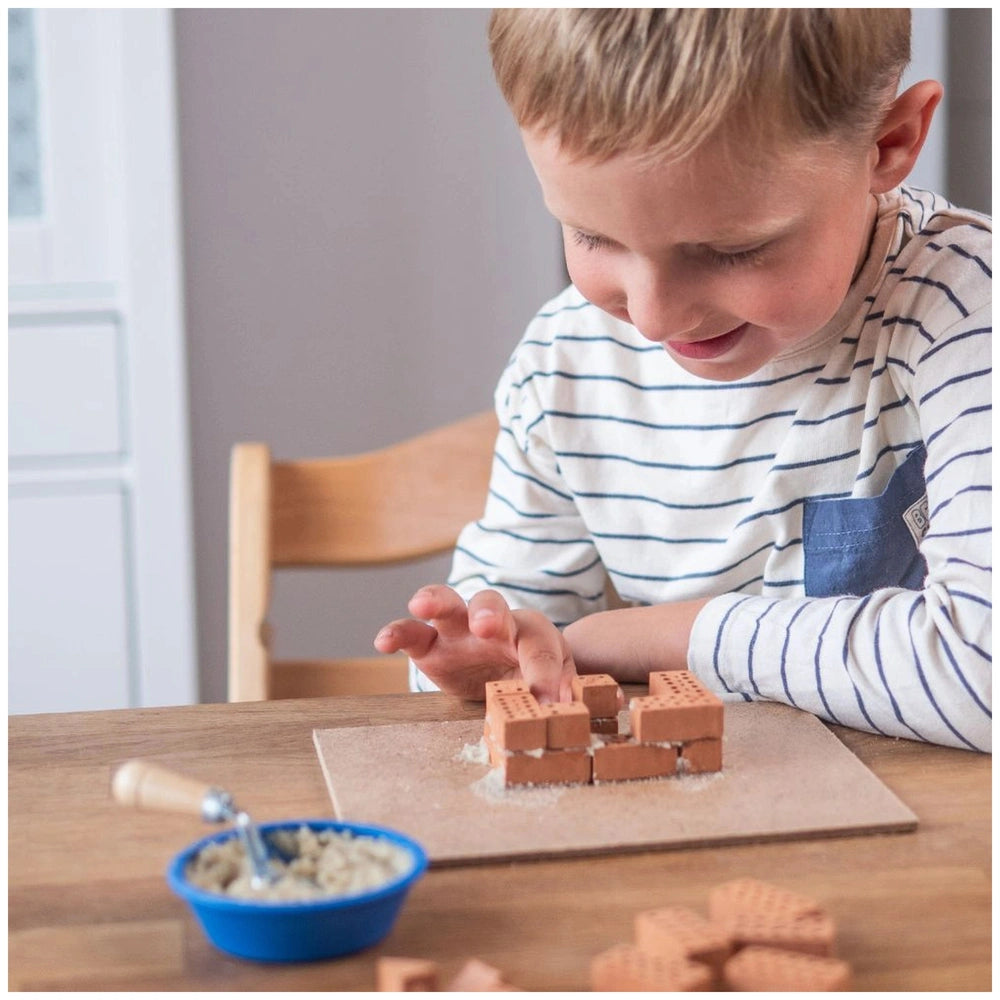 Teifoc accessory set with 100 pieces displayed as a child builds with brown blocks at a wooden table, focused and engaged.