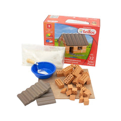 Teifoc craft kit includes wooden blocks, a blue bowl, and sand for building a small family home.