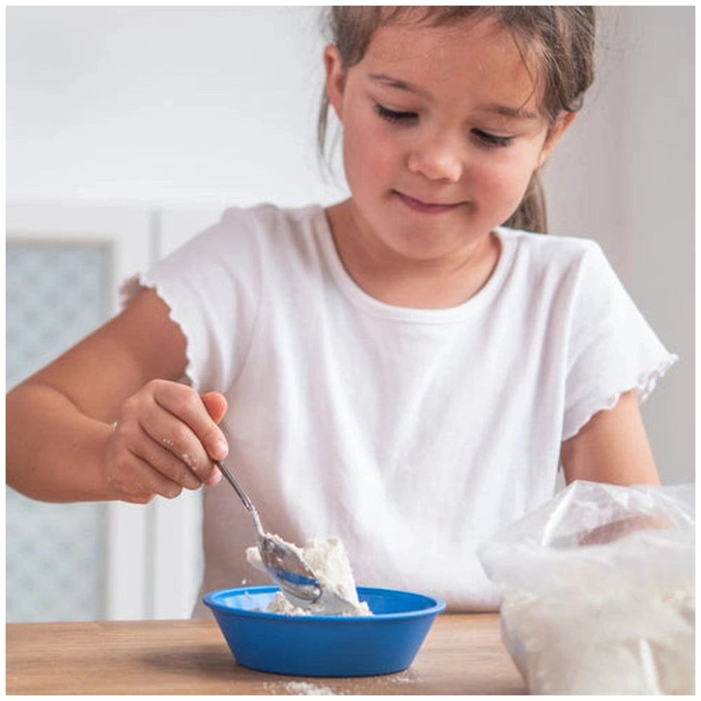 Teifoc water-soluble mortar is featured alongside a young girl happily eating from a blue bowl at a wooden table.