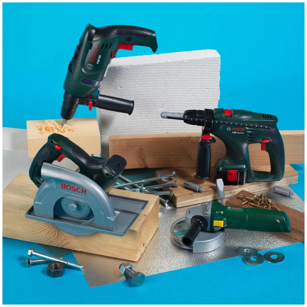 Theo Klein Bosch circular saw with power drills and screwdriver, featuring green, black, and gray components on a wooden surf