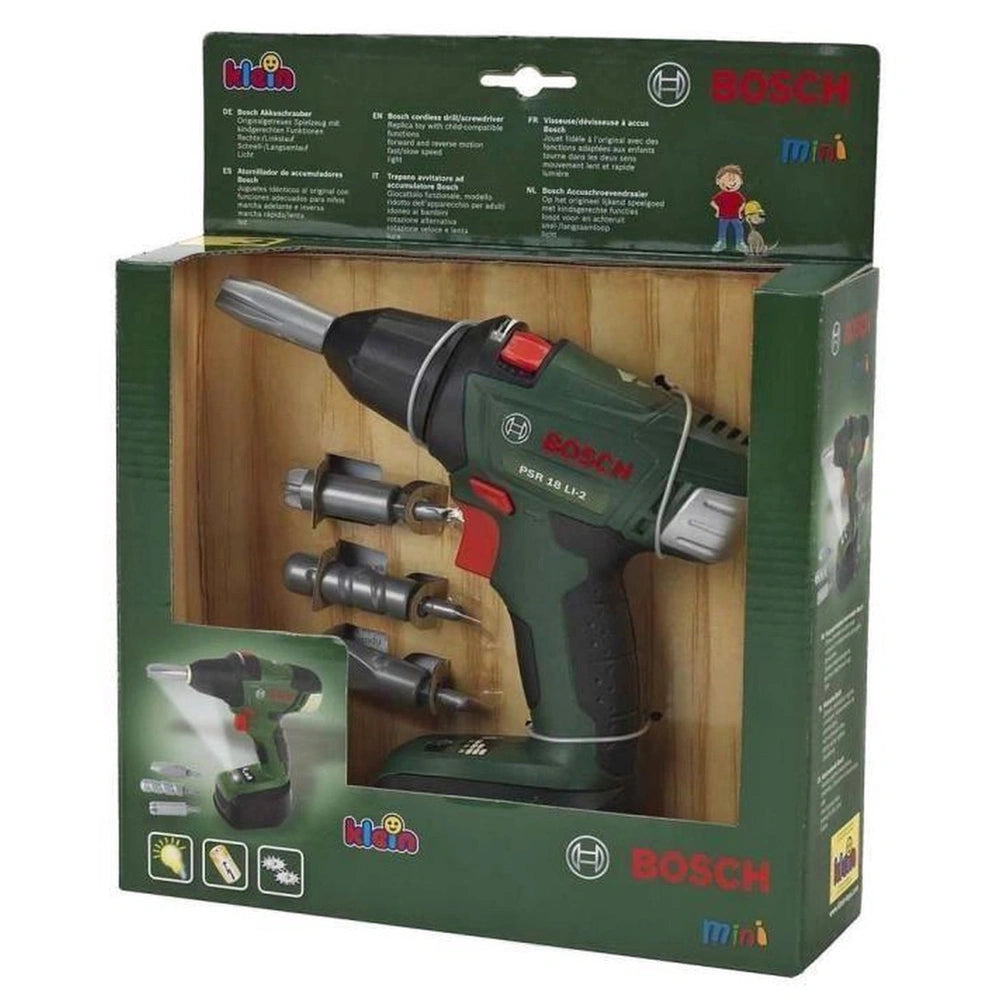 Theo Klein Bosch cordless drill in green, visible through clear packaging with battery pack, charger, and accessories.