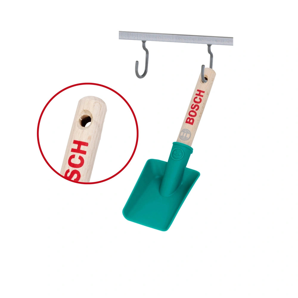 Theo Klein Bosch garden hand shovel with a green plastic scoop, wooden handle, and metal hook, featuring "BOSCH" branding.