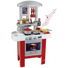 Theo Klein Miele kitchen starter set featuring a red and white oven with a glass door, silver knobs, and multiple burners.